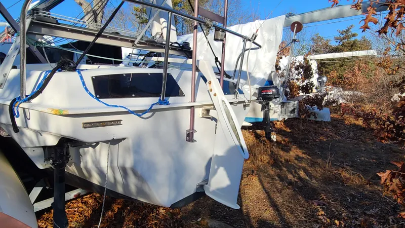 Slide: The Image of 1987 Corsair F-27 sailboat on land, surrounded by autumn foliage. - 9