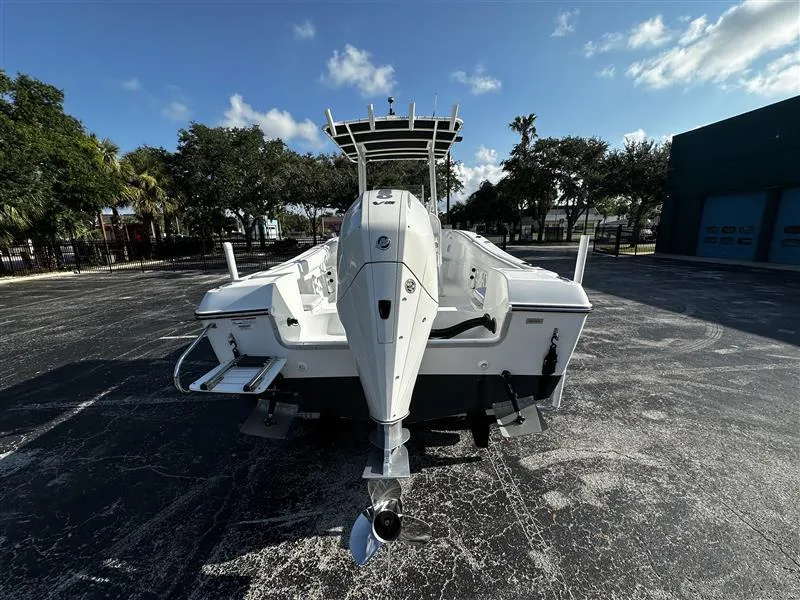 Slide: The Image of 2022 Clearwater 2300 CC boat, rear view, parked outdoors on a sunny day. - 8