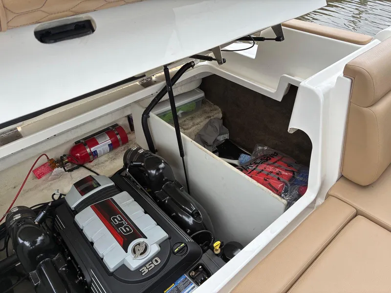 Slide: The Image of Engine compartment of 2021 Sea Ray SDX 290 boat with storage and fire extinguisher. - 15