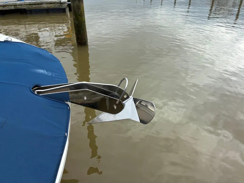 Slide: The Image of 2021 Sea Ray SDX 290 boat with anchor, docked on calm water. - 2