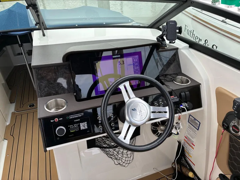 Slide: The Image of 2021 Sea Ray SDX 290 boat dashboard with steering wheel and digital display. - 5