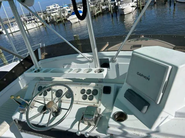 Slide: The Image of 1989 Post 43 Sport Fisherman boat helm with Garmin navigation, docked at marina. - 10