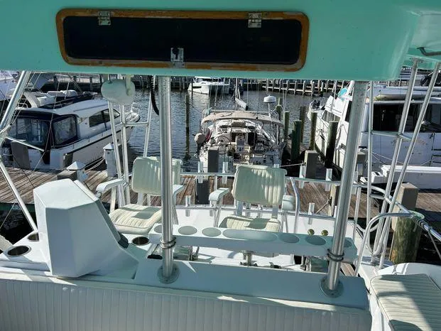 Slide: The Image of 1989 Post 43 Sport Fisherman boat interior with seating, docked at marina. - 12
