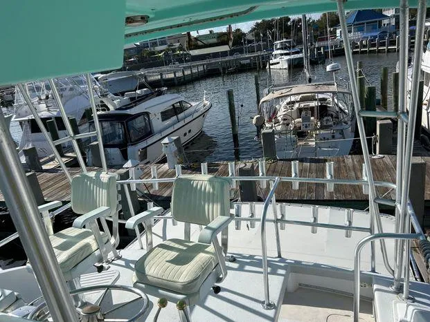 Slide: The Image of 1989 Post 43 Sport Fisherman boat docked at marina with other vessels. - 13