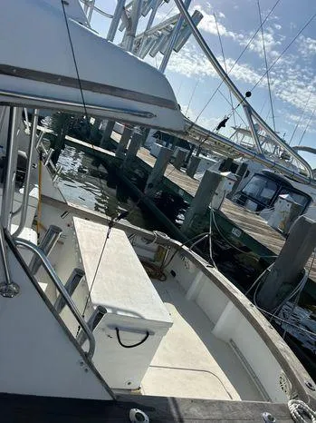 Slide: The Image of 1989 Post 43 Sport Fisherman boat docked at marina under clear sky. - 15