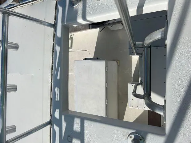 Slide: The Image of 1989 Post 43 Sport Fisherman boat interior with metal railings and storage compartment. - 16