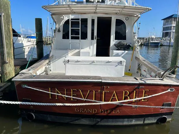 Slide: The Image of 1989 Post 43 Sport Fisherman boat named "Inevitable" docked at marina, Grand Isle, LA. - 2