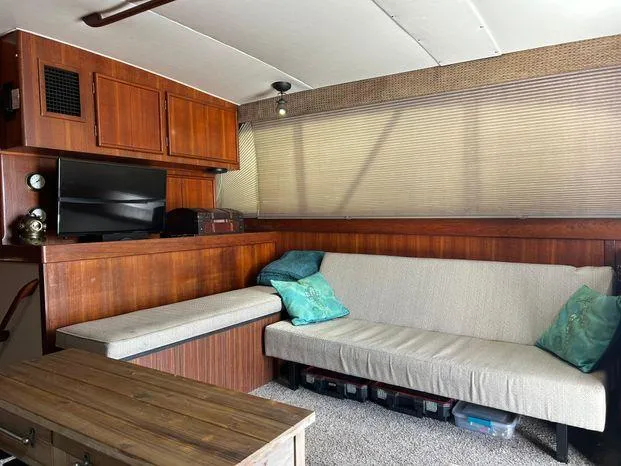 Slide: The Image of Interior of 1989 Post 43 Sport Fisherman with wood paneling, sofa, and TV. - 20