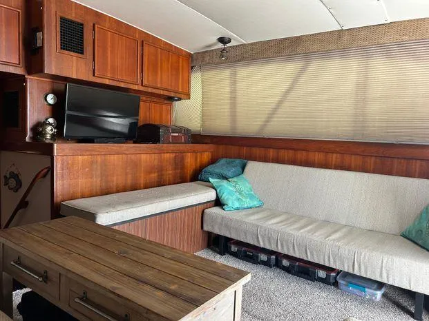 Slide: The Image of Interior of 1989 Post 43 Sport Fisherman with wood paneling, sofa, and TV. - 24