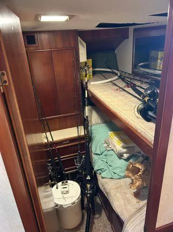 Slide: The Image of 1989 Post 43 Sport Fisherman cabin with fishing rods and bunk beds. - 29