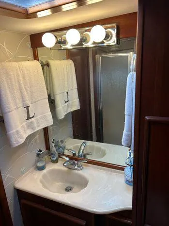 Slide: The Image of 1989 Post 43 Sport Fisherman bathroom with sink, mirror, and towels. - 33
