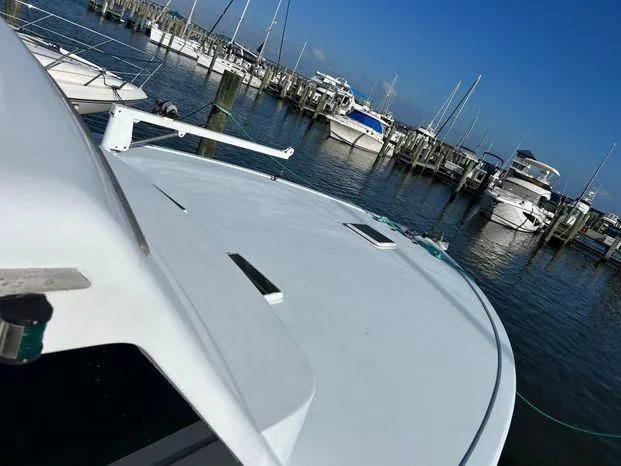 Slide: The Image of 1989 Post 43 Sport Fisherman boat docked in a marina with other vessels. - 6