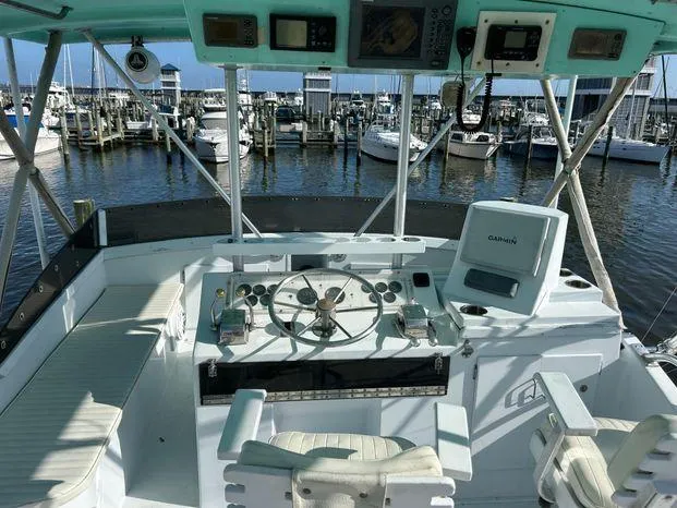 Slide: The Image of 1989 Post 43 Sport Fisherman boat helm with marina view. - 8