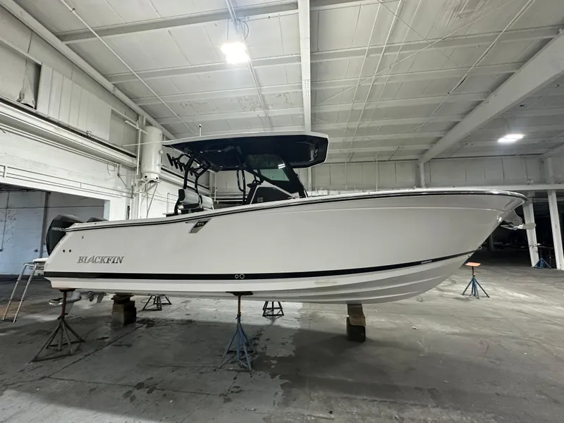 The Image of 2025 Blackfin 272CC boat in a warehouse, side view. - 0