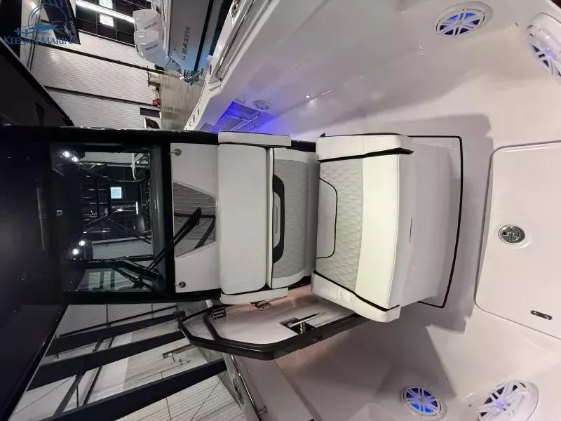 Slide: The Image of 2025 Blackfin 272CC boat interior with white seating and modern design. - 11