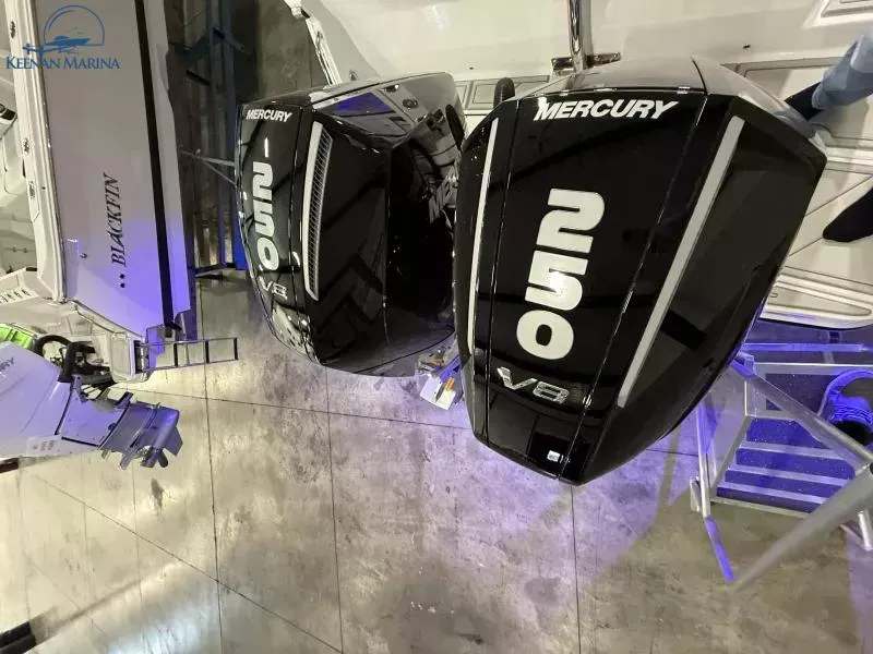 Slide: The Image of 2025 Blackfin 272CC with dual Mercury V8 outboard engines at a marina. - 13