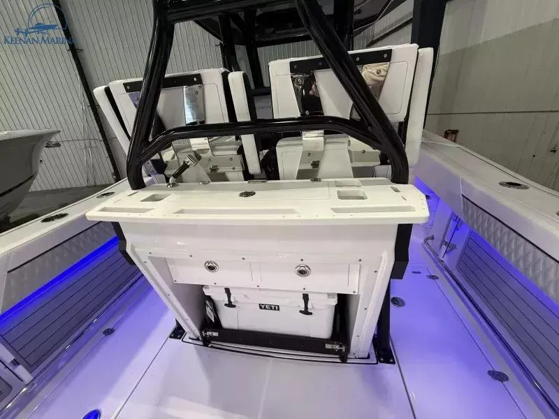 Slide: The Image of 2025 Blackfin 272CC boat interior with seating and storage, featuring blue LED lighting. - 5