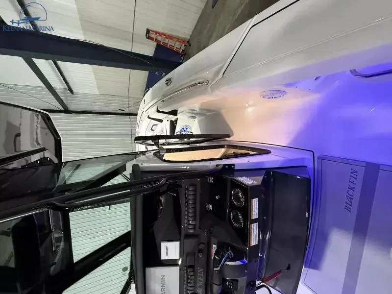 Slide: The Image of 2025 Blackfin 272CC boat interior with illuminated dashboard and sleek design. - 8