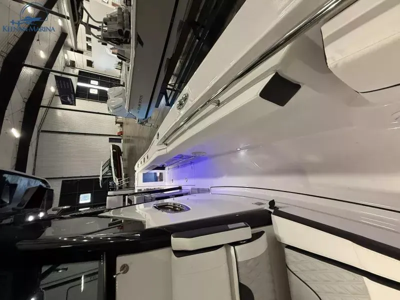 Slide: The Image of 2025 Blackfin 272CC boat interior with sleek design and ambient lighting. - 9