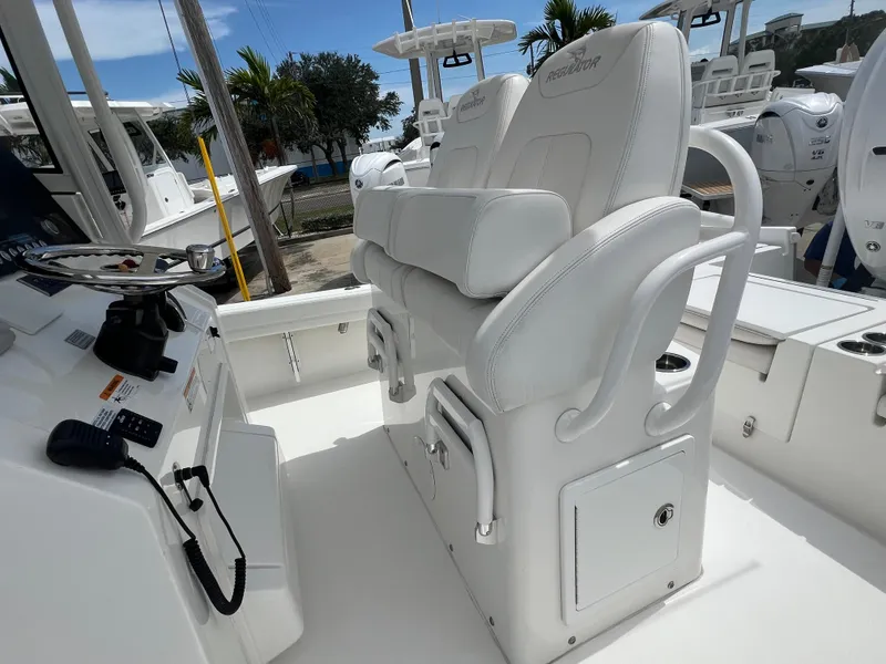 Slide: The Image of 2023 Regulator 26XO boat interior with white seating and control panel. - 10