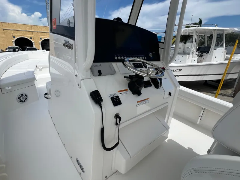 Slide: The Image of 2023 Regulator 26XO boat console with steering wheel and navigation equipment. - 12