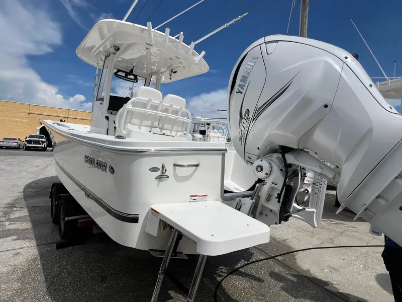 Slide: The Image of 2023 Regulator 26XO boat with Yamaha engine, parked outdoors under a clear sky. - 14
