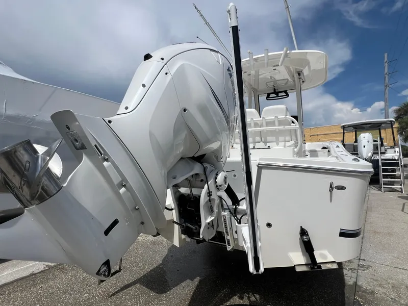 Slide: The Image of 2023 Regulator 26XO boat with powerful outboard motor, viewed from the rear. - 15