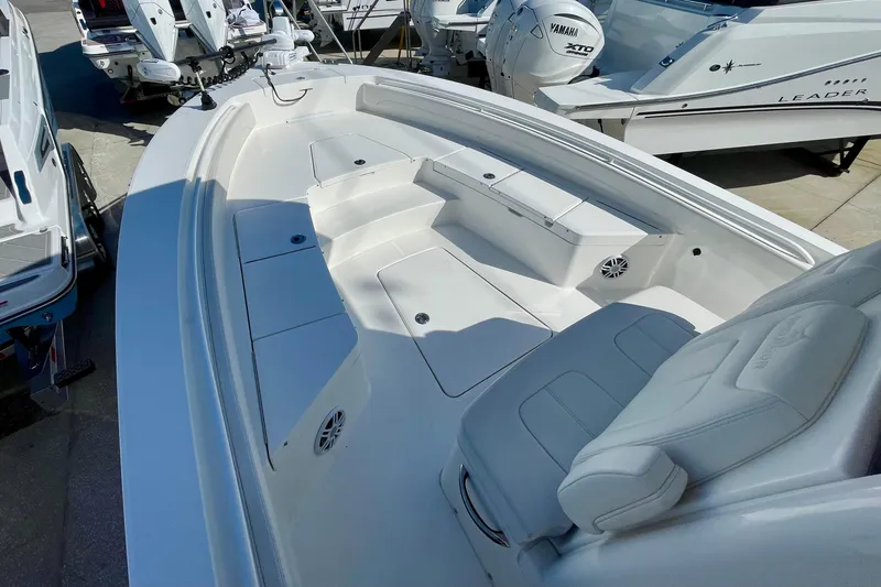 Slide: The Image of 2023 Regulator 26XO boat interior with white seating and spacious deck layout. - 6