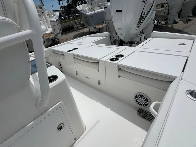 Slide: The Image of 2023 Regulator 26XO boat interior with storage compartments and Yamaha outboard engines. - 9