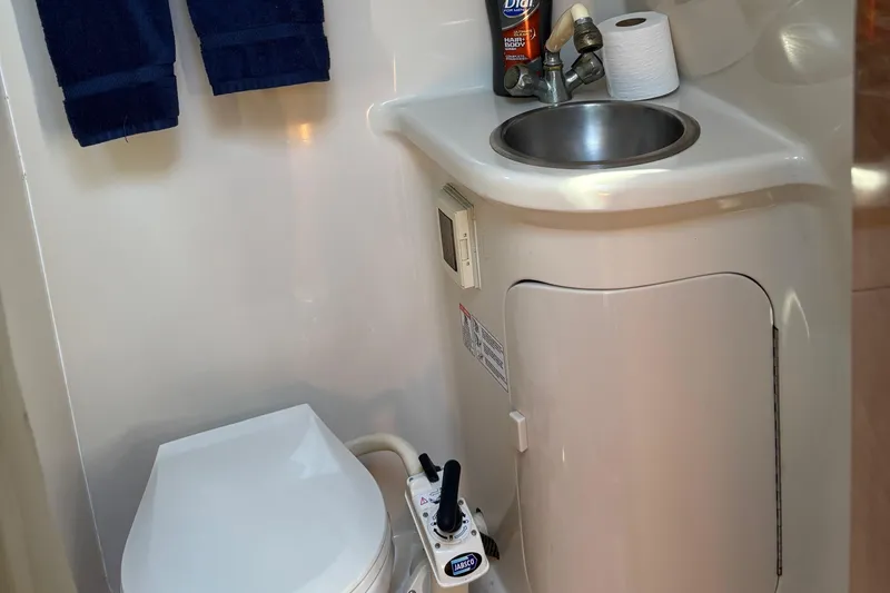 Slide: The Image of Compact bathroom in 2001 Regal Cruiser Commodore with sink and toilet. - 4