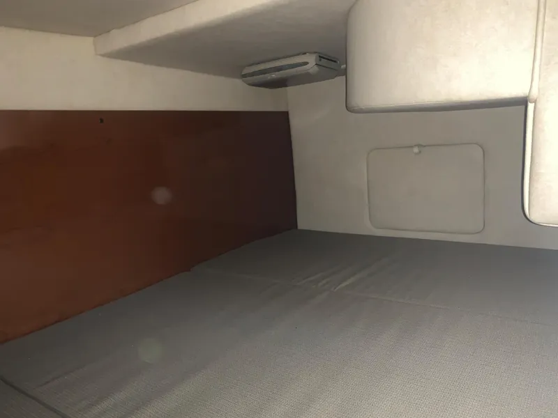 Slide: The Image of Interior cabin of 2009 Sea Ray 270 Sundancer boat, featuring a bed and storage. - 14