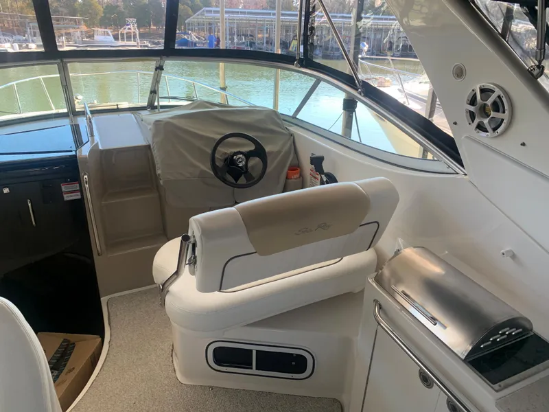 Slide: The Image of 2009 Sea Ray 270 Sundancer cockpit with helm, seating, and water view. - 6