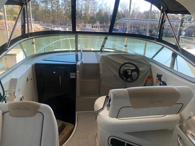 Slide: The Image of Interior view of 2009 Sea Ray 270 Sundancer boat cockpit with steering wheel and seating. - 7