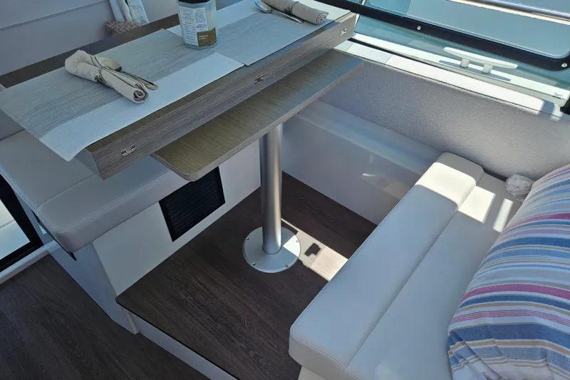 Slide: The Image of Interior dining area of 2026 Jeanneau NC 895 Sport Series 2 boat with table and seating. - 12