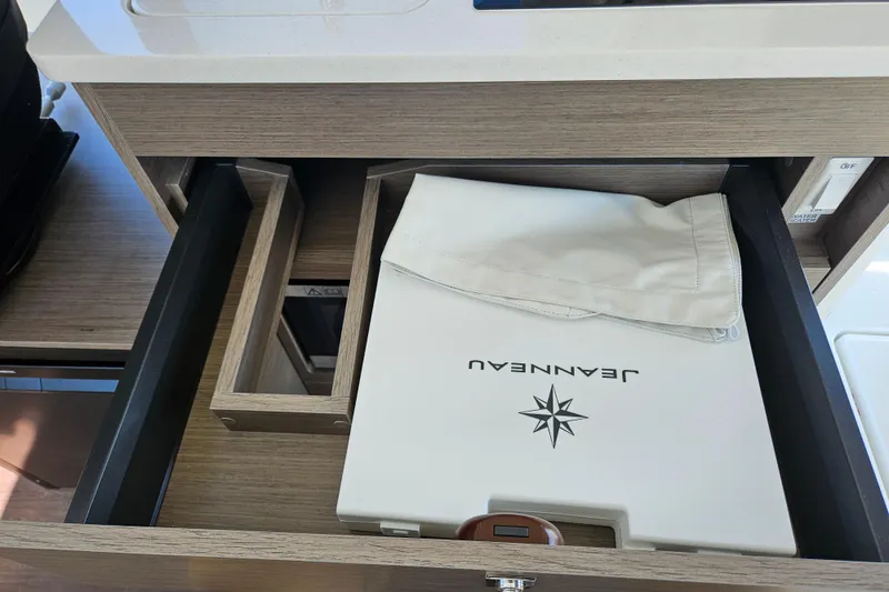 Slide: The Image of Open drawer in Jeanneau NC 895 Sport Series 2, showcasing branded storage. - 15