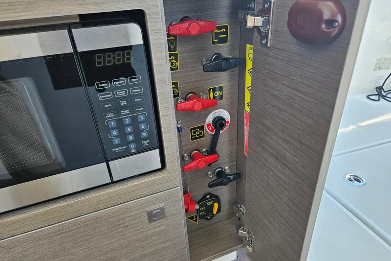 Slide: The Image of Control panel and microwave inside Jeanneau NC 895 Sport Series 2, 2026 model. - 17