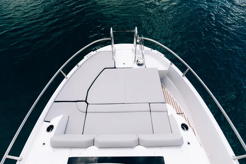 Slide: The Image of Front deck of 2026 Jeanneau NC895 Sport S2 boat with cushioned seating. - 3