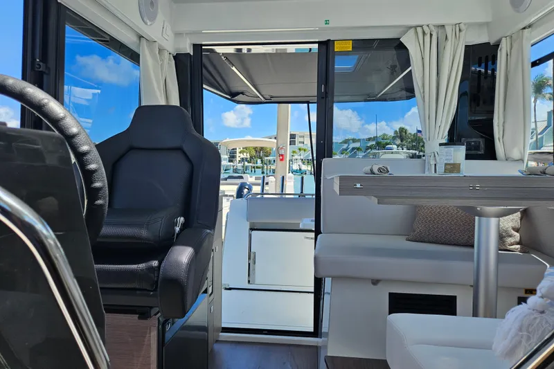 Slide: The Image of Interior of 2026 Jeanneau NC 895 Sport Series 2 boat, featuring seating and helm. - 32