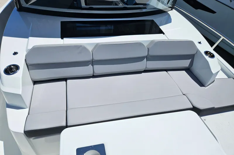 Slide: The Image of 2026 Jeanneau NC 895 Sport Series 2 boat seating area with gray cushions. - 37