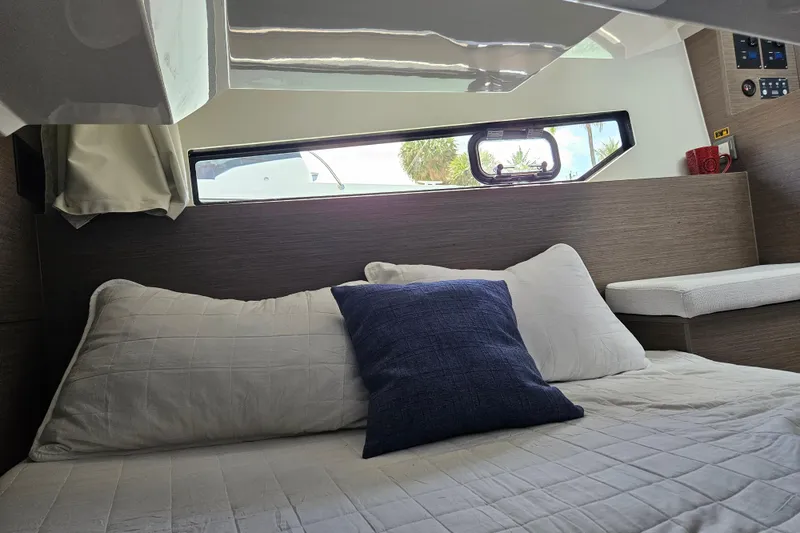 Slide: The Image of Interior cabin of 2026 Jeanneau NC 895 Sport Series 2 with cozy bedding and window view. - 47
