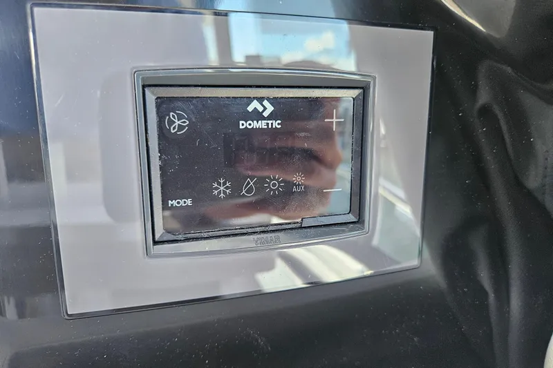Slide: The Image of Dometic control panel on 2026 Jeanneau NC 895 Sport Series 2 boat dashboard. - 49