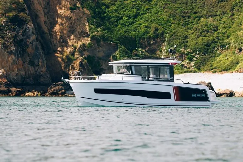 Slide: The Image of 2026 Jeanneau NC895 Sport S2 boat cruising near rocky coastline. - 5