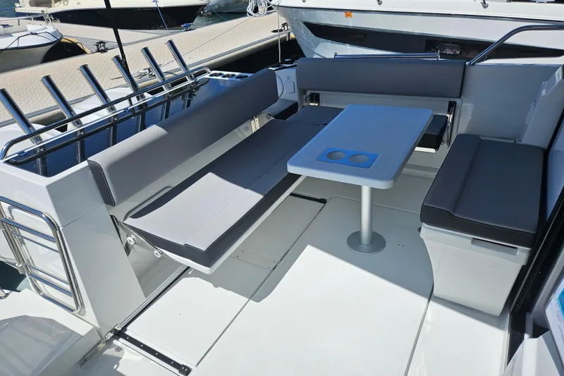 Slide: The Image of 2026 Jeanneau NC 895 Sport Series 2 boat interior with seating and table. - 51