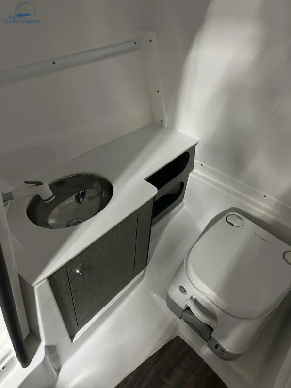 Slide: The Image of 2024 Monterey M6 boat bathroom with sink and portable toilet. - 11
