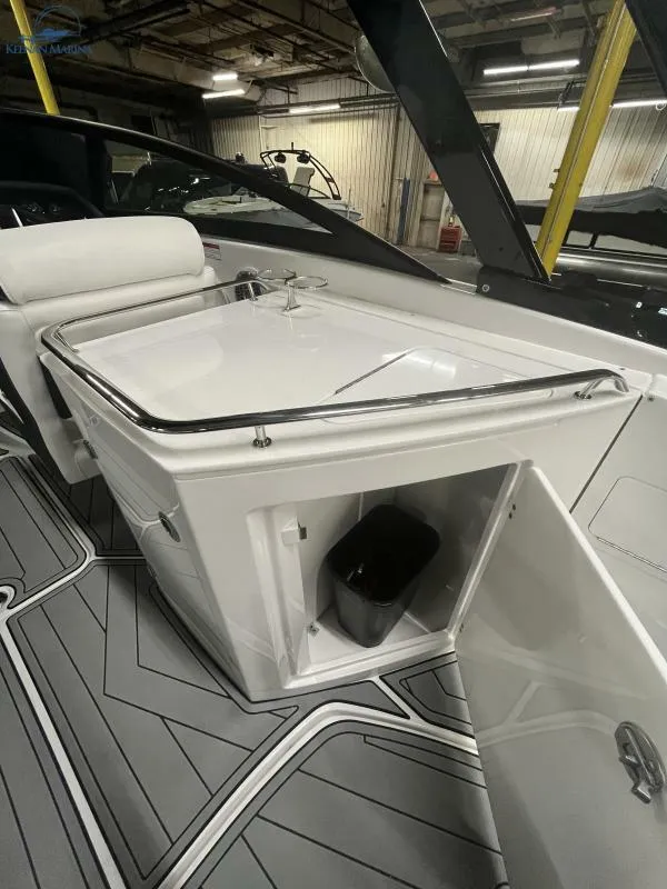 Slide: The Image of 2024 Monterey M6 boat interior with open storage compartment and sleek design. - 14