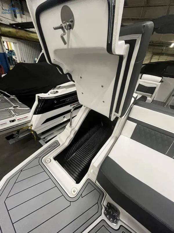 Slide: The Image of 2024 Monterey M6 boat interior with open storage compartment, showcasing sleek design and functionality. - 16