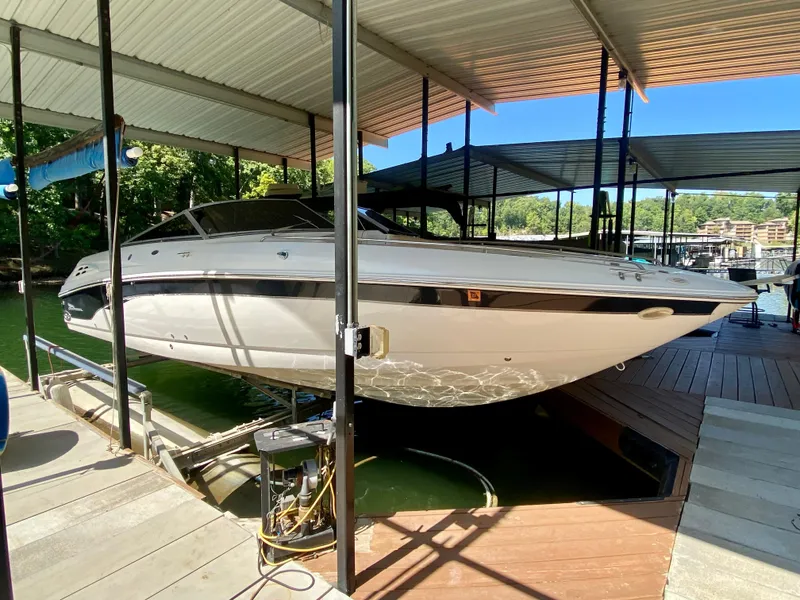 Slide: The Image of 2000 Chaparral 280 SSi boat docked under a covered marina. - 15