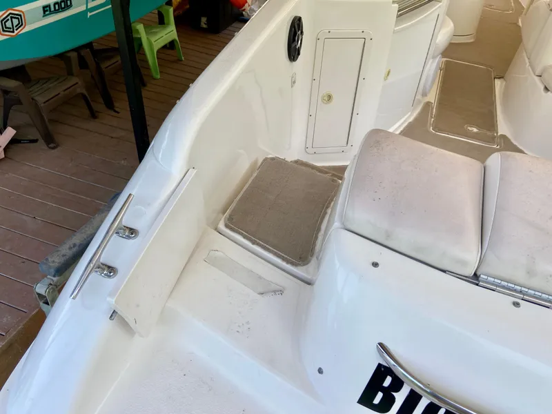 Slide: The Image of 2000 Chaparral 280 SSi boat interior with cushioned seating and storage compartment. - 21