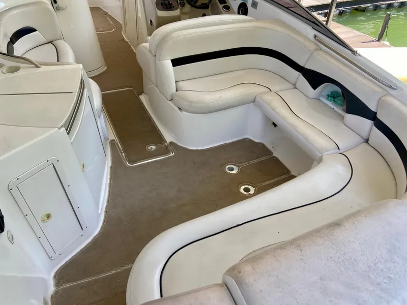 Slide: The Image of 2000 Chaparral 280 SSi boat interior with white seating and beige carpet. - 22