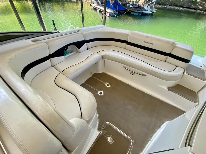 Slide: The Image of 2000 Chaparral 280 SSi boat interior with beige seating and lake view. - 24